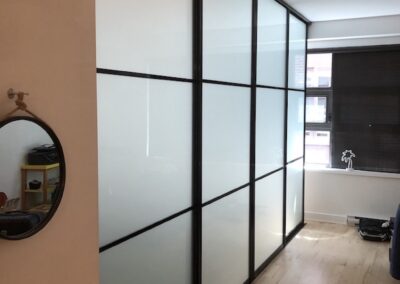 frosted glass and glossy black frames sliding doors for room separation