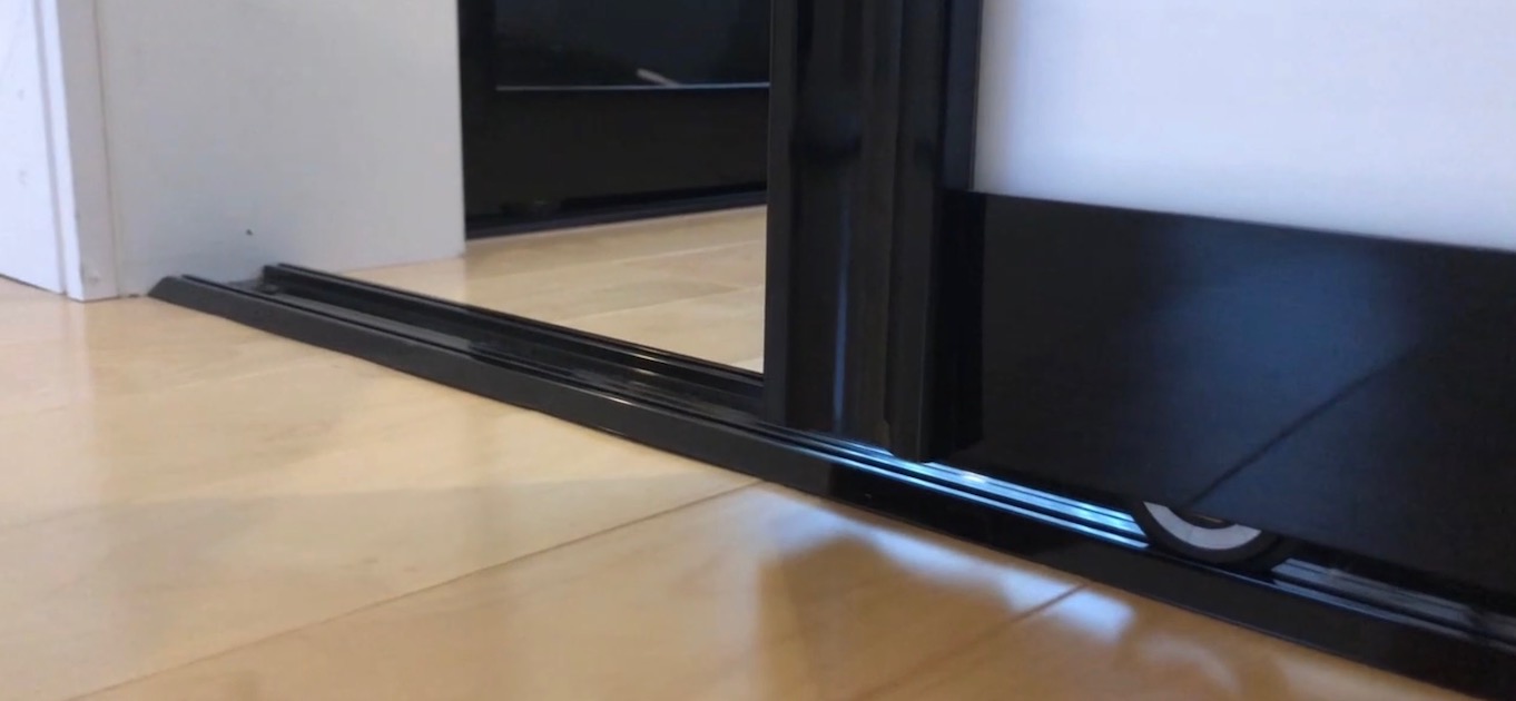 Bottom-track sliding door system for room separation