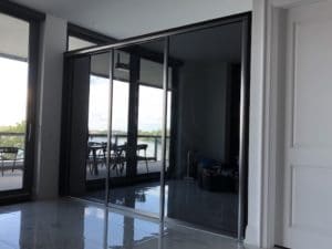 custom sliding door system with tinted mirrors
