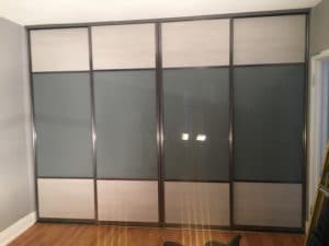 grey glass and melamine combination sliding doors for closet and room separation